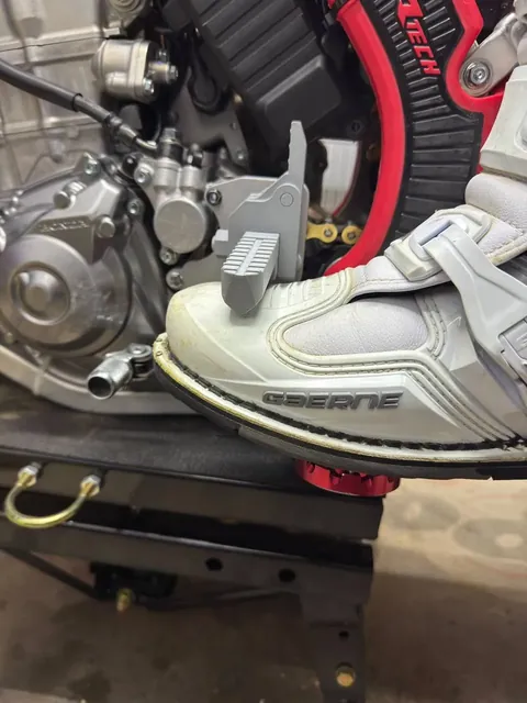 Rider’s boot on a 3D-printed footpeg prototype mounted on a Honda